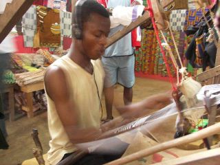 A man weaves kente cloth using a traditional loom in Bonwire village, Ashanti region, Ghana.